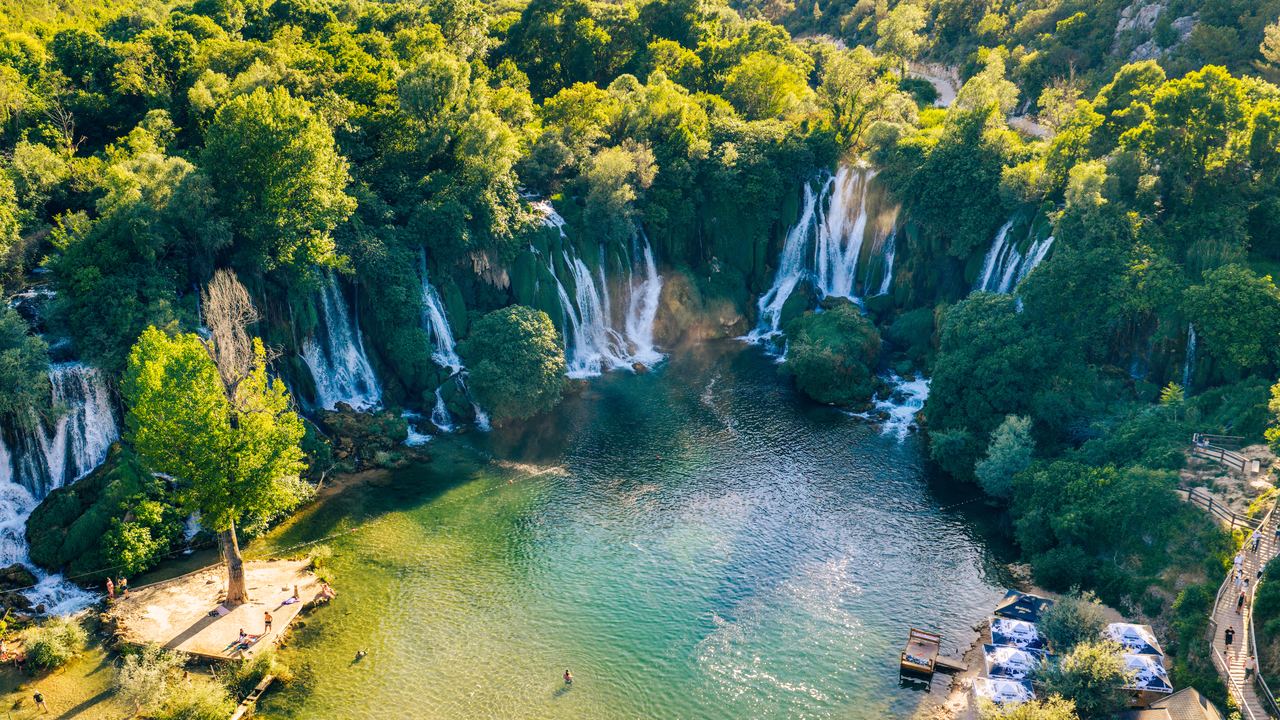 Aerial view of the Kravica Waterfalls and the green pool beneath them, Bosnia and Herzegovina