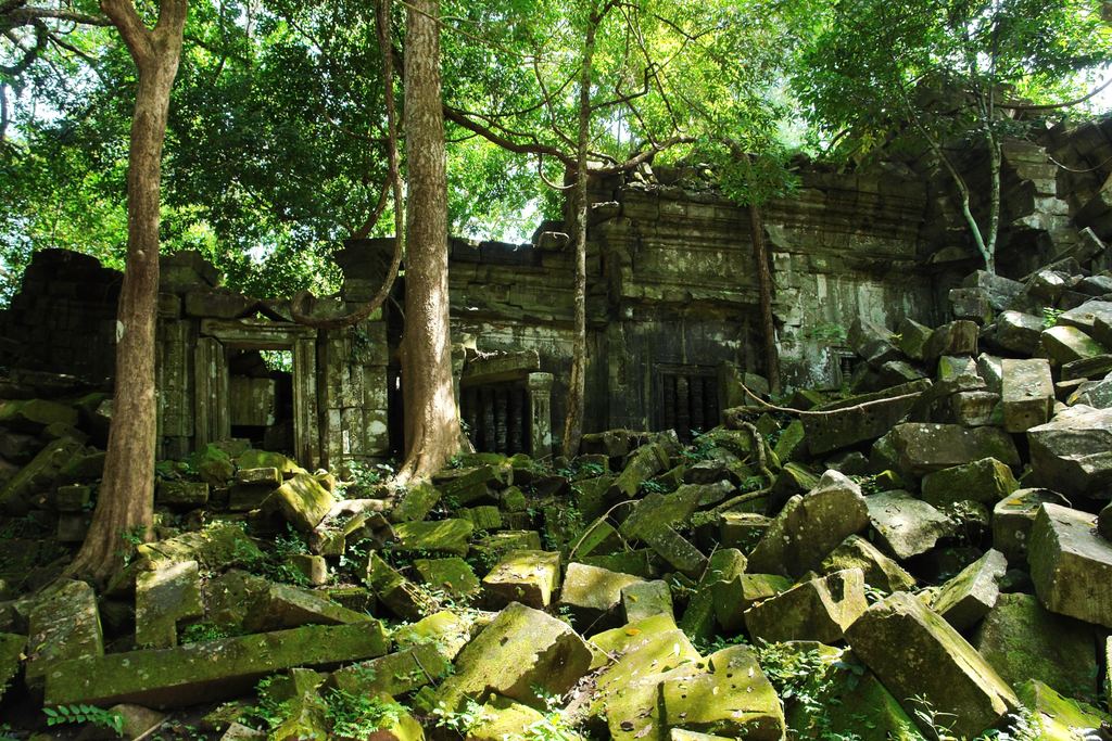Collapsed stone blocks and a jungle-covered gateway at Beng Mealea temple, Siem Reap Province