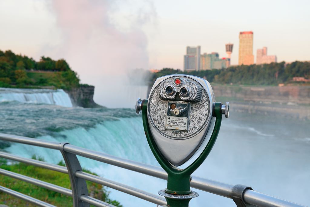 Coin-operated binocular viewer on a railing overlooking the American Falls at Niagara