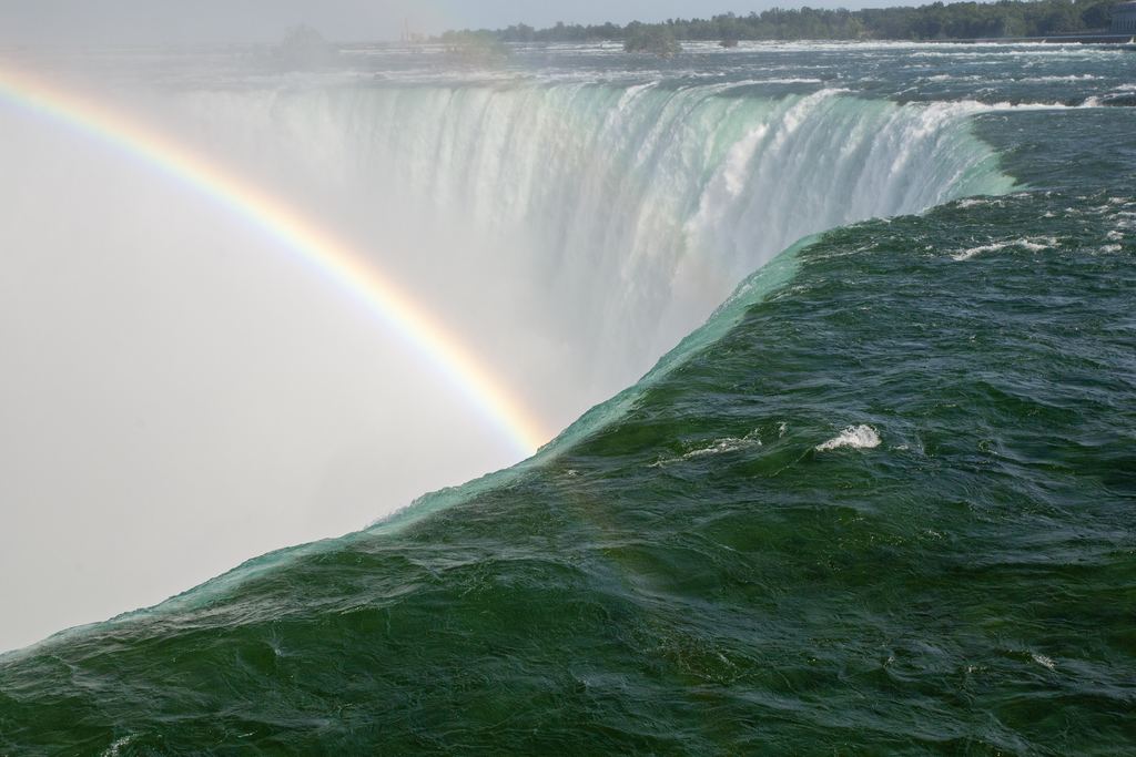 Crest of the Horseshoe Falls at Niagara with a rainbow in the mist, seen from the Canadian shore