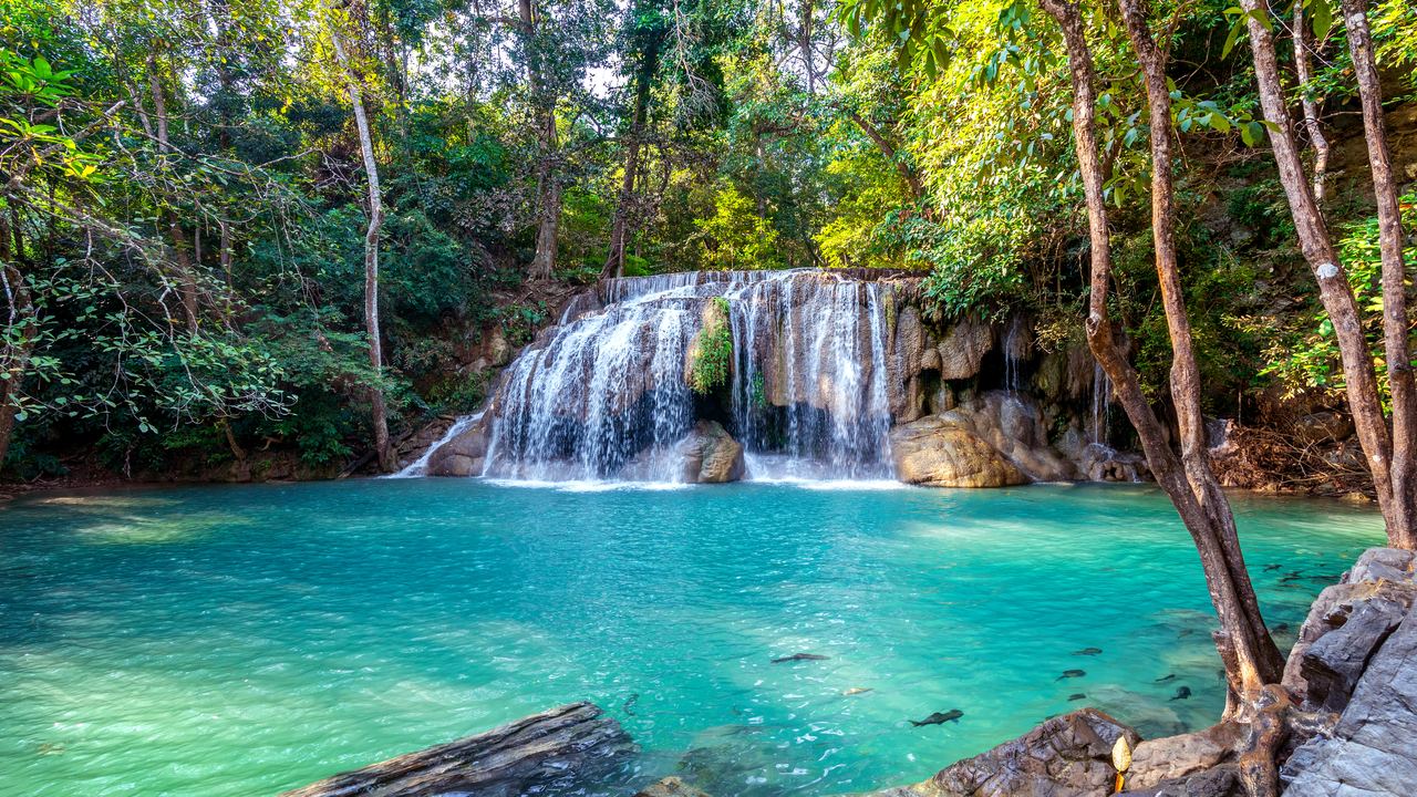 A tier of Erawan Falls dropping into an emerald pool in Kanchanaburi, Thailand