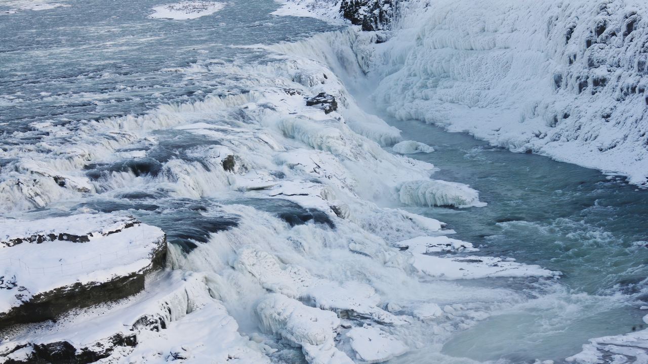 Gullfoss in Iceland in winter, with ice along the rapids and snow on the rocks