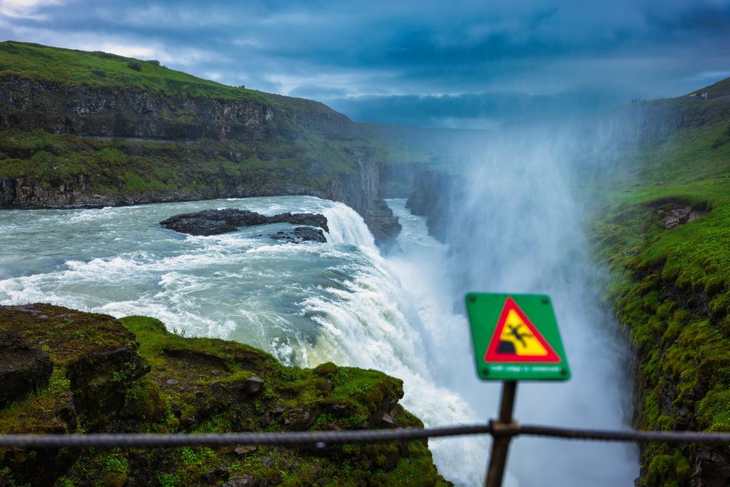 Hazard sign and rope barrier at the edge of Gullfoss waterfall in Iceland