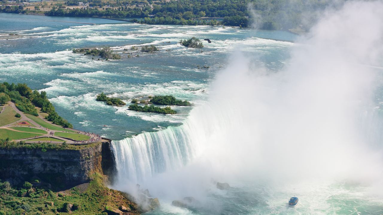 Aerial view of the Horseshoe Falls in Niagara Falls with a tour boat in the mist at the base