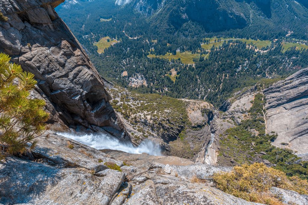 View from the rocky top of a waterfall in Yosemite National Park down into the valley