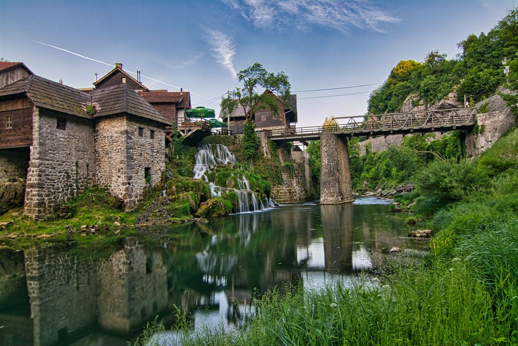 Stone mill and wooden bridge beside the falls at Rastoke, Slunj, Croatia