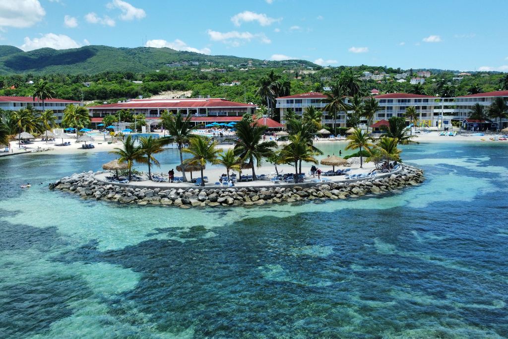 Resort hotels on a rocky beach with turquoise sea at Montego Bay, Jamaica