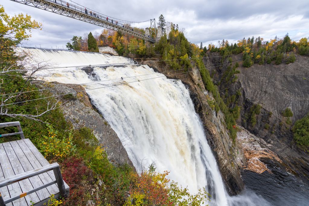 Montmorency Falls in autumn with the suspension bridge and a lookout deck, Quebec