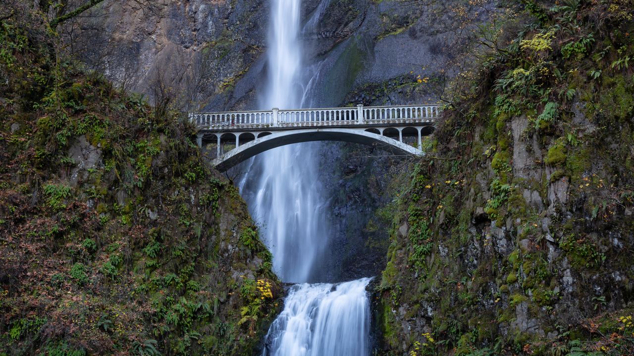 Multnomah Falls above the Benson Bridge in the Columbia River Gorge, Oregon, with autumn foliage