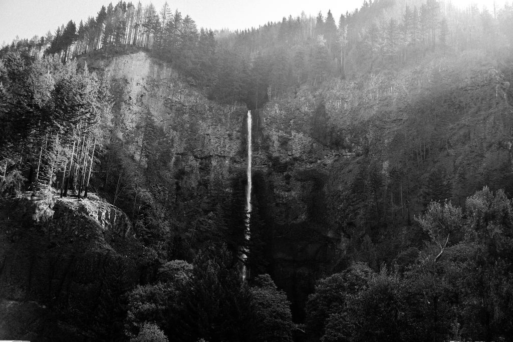 Multnomah Falls seen from a distance in the Columbia River Gorge, Oregon, in black and white