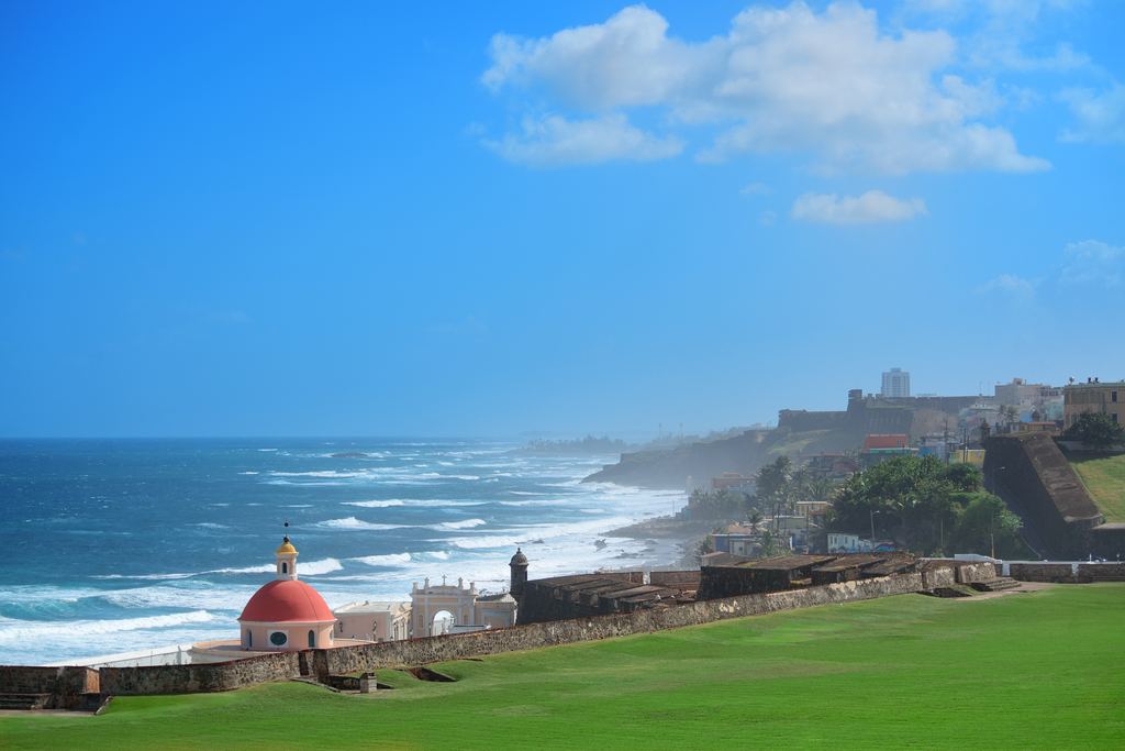 Old San Juan seafront with the cemetery chapel dome and waves on the coast