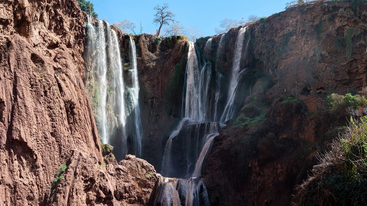 Ouzoud waterfalls dropping over red cliffs in Morocco's Atlas mountains