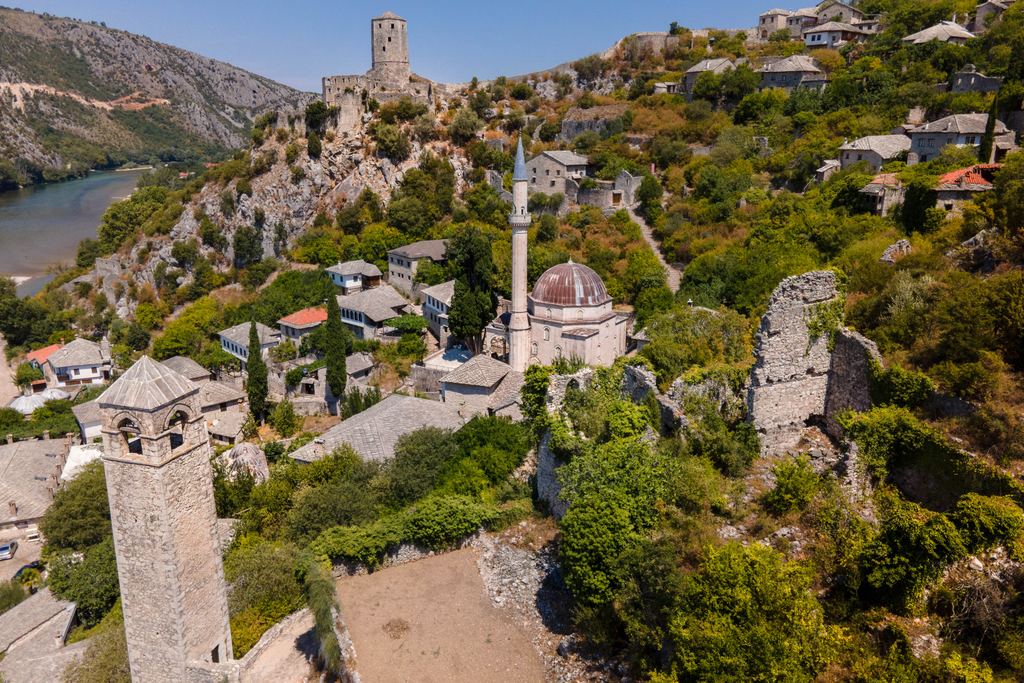Aerial view of Počitelj with its stone tower, mosque and the Neretva river, Bosnia and Herzegovina