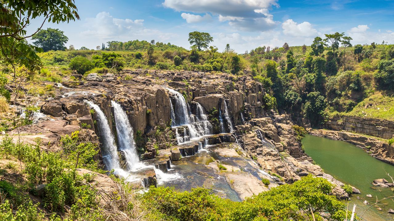 Pongour Falls near Da Lat, with water falling over dark rock into a green pool
