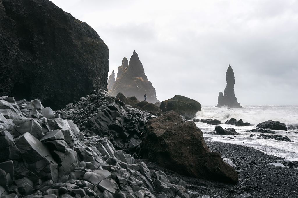 Basalt columns and the Reynisdrangar sea stacks on the black sand beach at Reynisfjara near Vík
