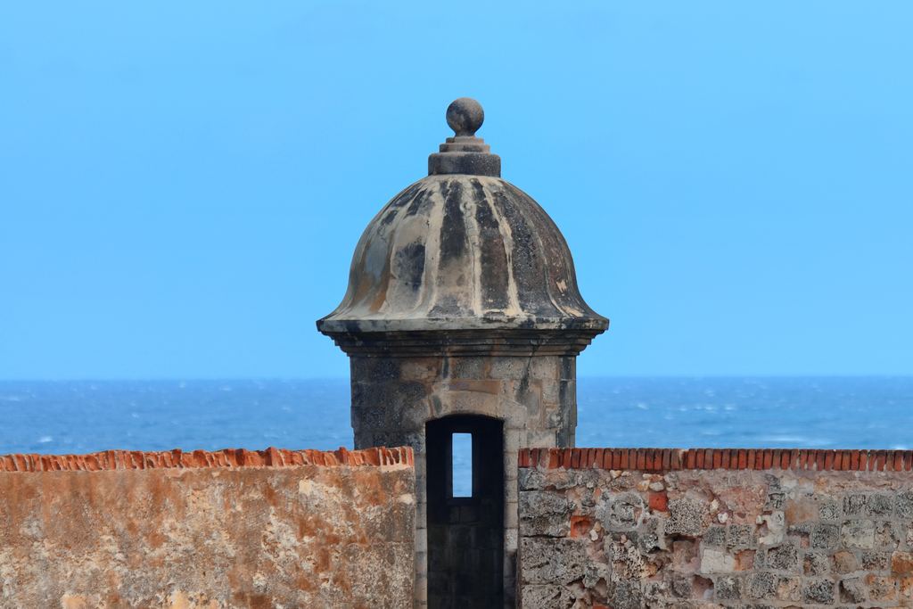 Stone sentry box on the walls of El Morro fort in Old San Juan with the sea behind