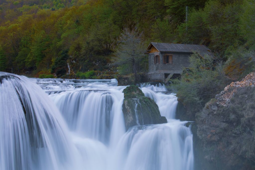 Štrbački buk waterfall on the Una river with a mill house above, Bosnia and Herzegovina