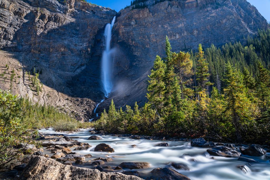 Takakkaw Falls on a rock wall above a rocky stream, Yoho National Park, British Columbia