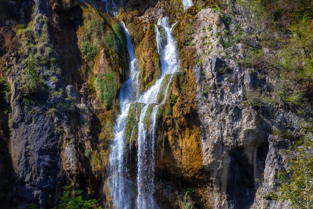 Tall waterfall over moss-covered rock at Plitvice Lakes National Park, Croatia