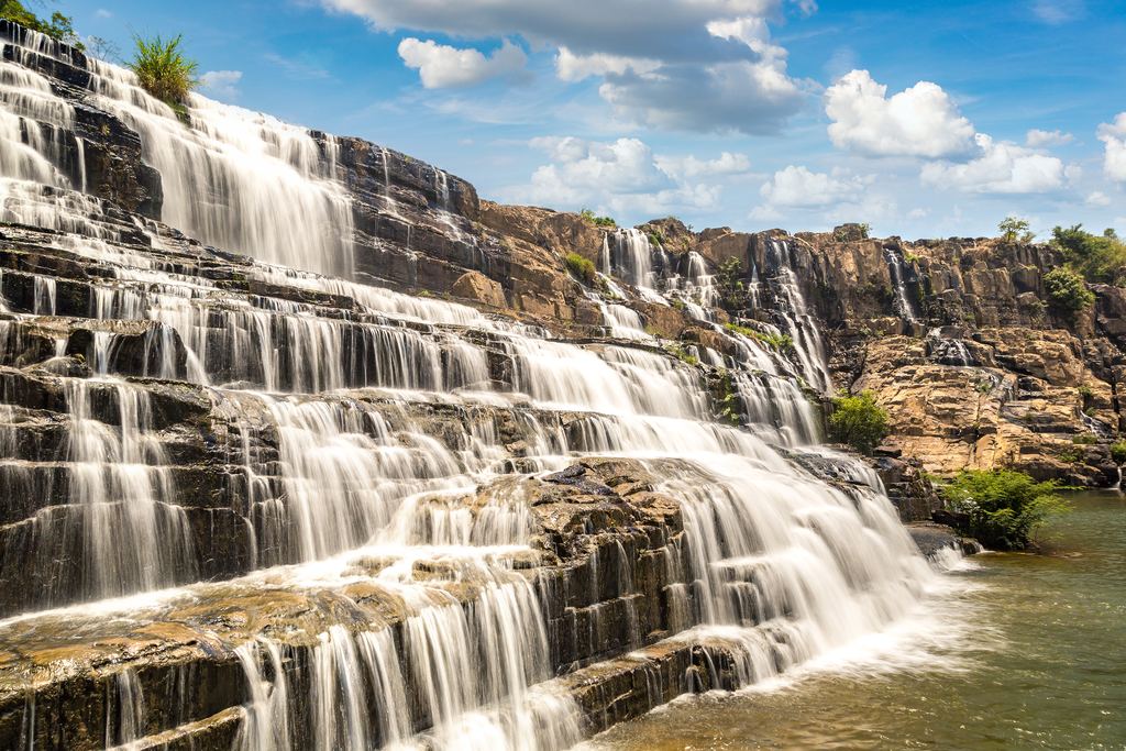 The stepped rock of Pongour Falls near Da Lat with water spread over several levels