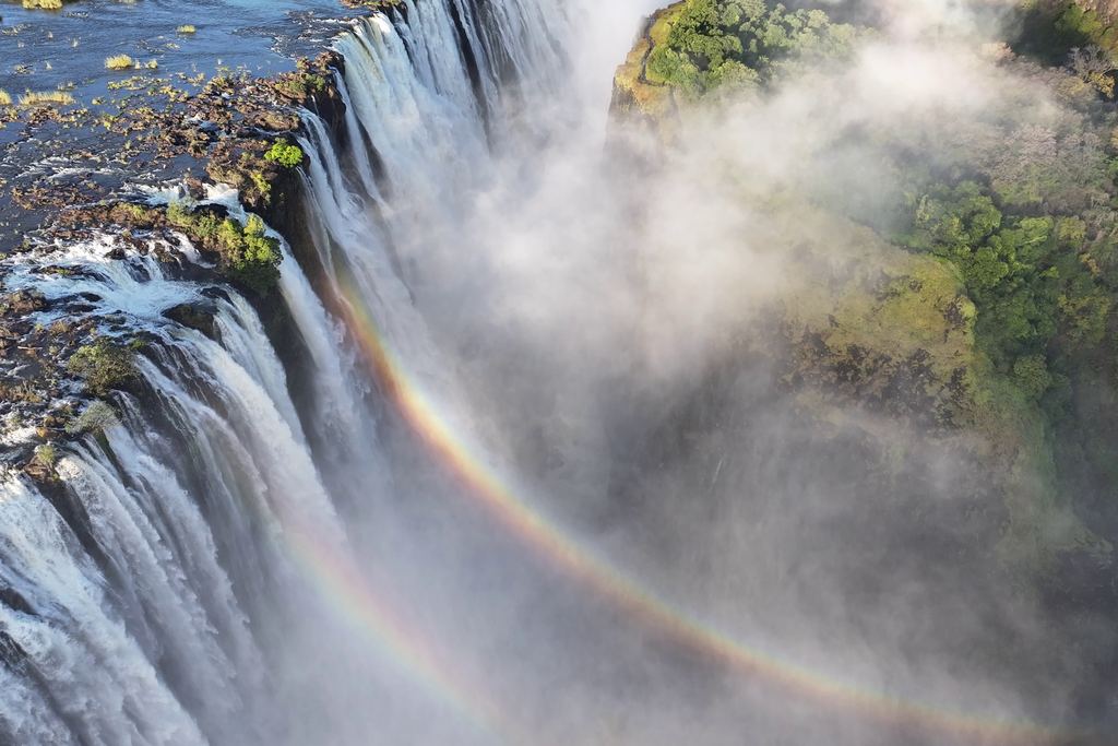 Aerial view of Victoria Falls with a rainbow over the spray, on the border of Zambia and Zimbabwe