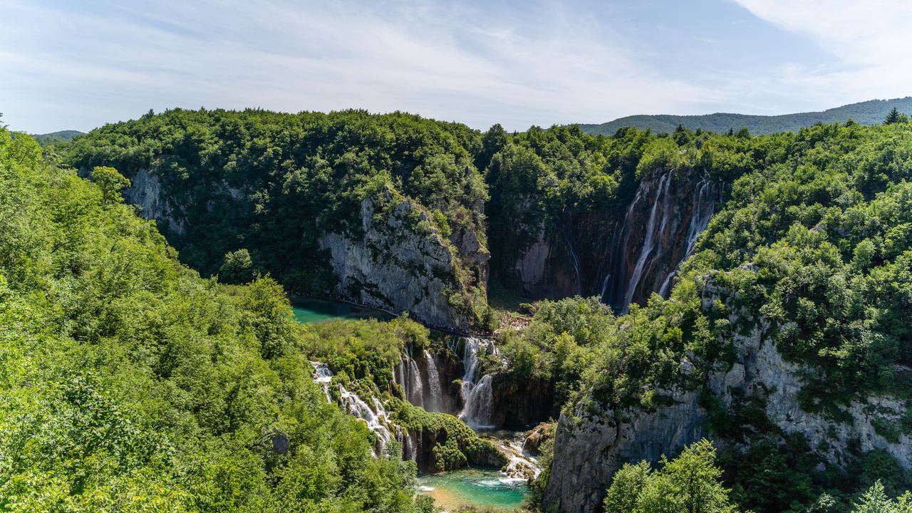 Wooded canyon at Plitvice Lakes National Park, Croatia, with waterfalls and turquoise lakes in the distance