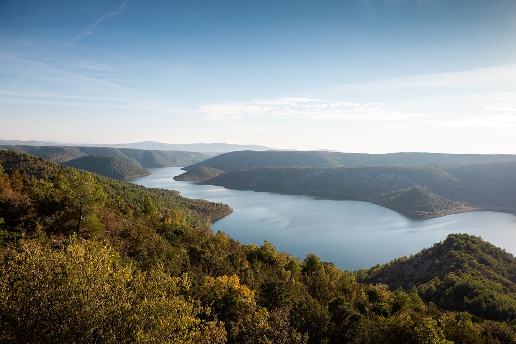 Aerial view of the Visovac lake on the Krka surrounded by wooded hills, Croatia