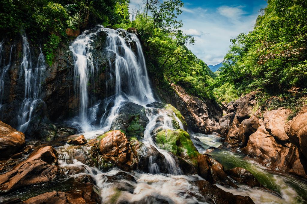 A small waterfall over dark rock near Cat Cat village, Sapa, Lao Cai province