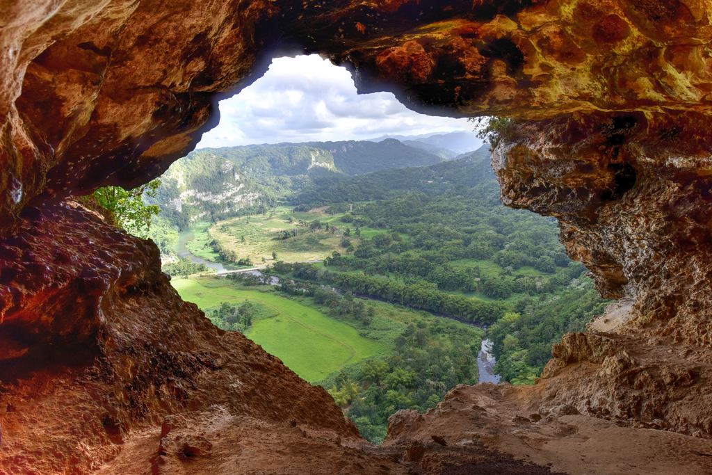 View over a green valley through the window opening of Cueva Ventana near Arecibo, Puerto Rico