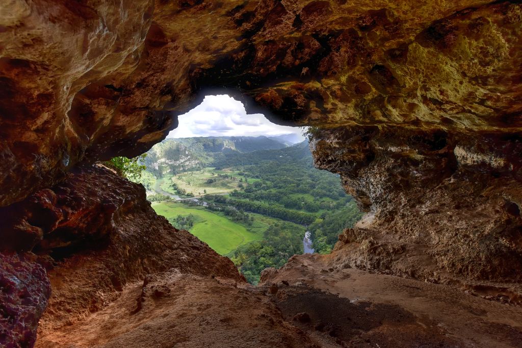 View over a green valley through the window opening of Cueva Ventana near Arecibo, Puerto Rico
