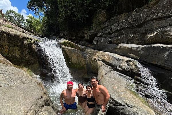 El Yunque River Pools, Big Waterslide and Beach Day Trip by Van from San Juan